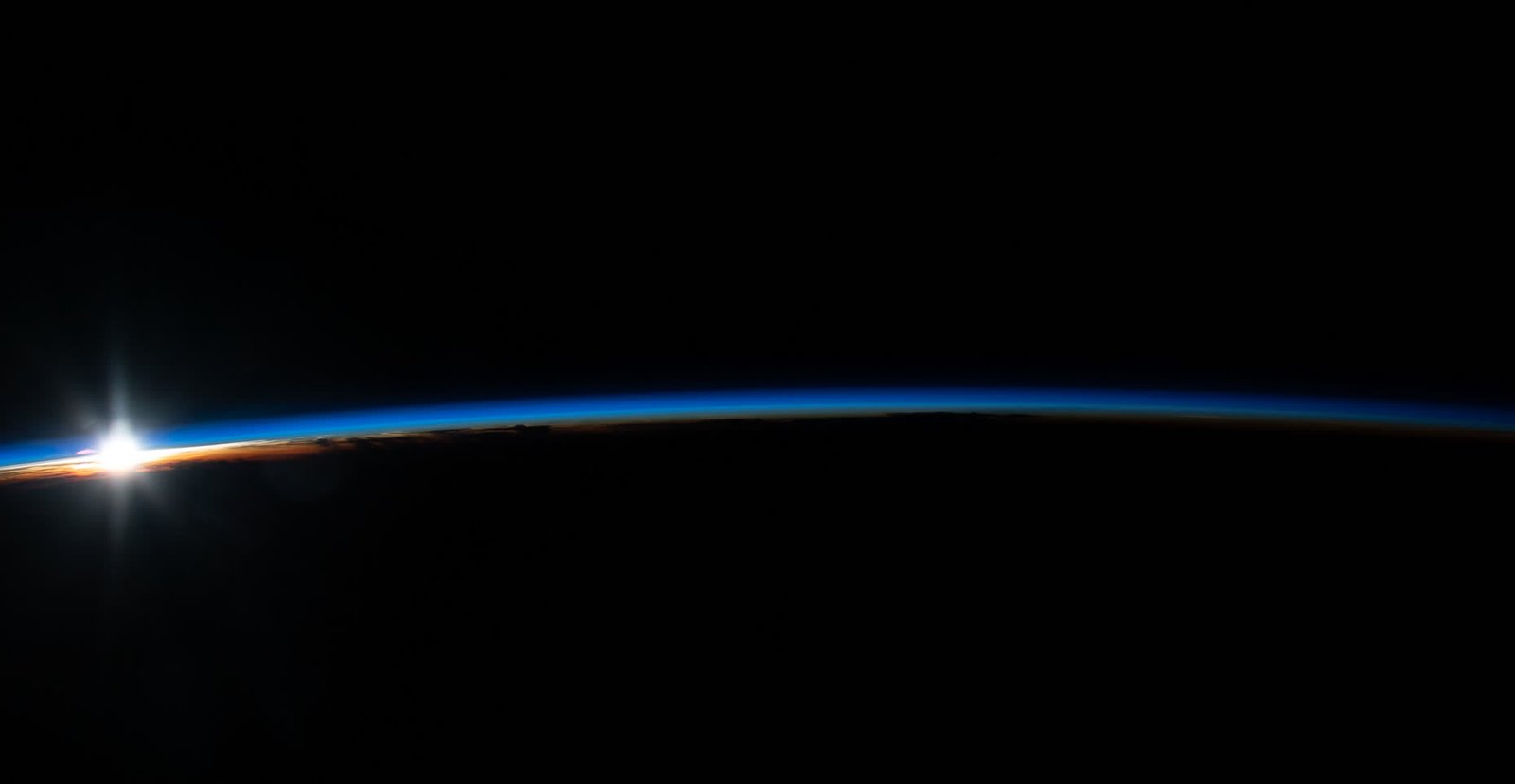 Camera viewfinder framing a sunrise over the Earth